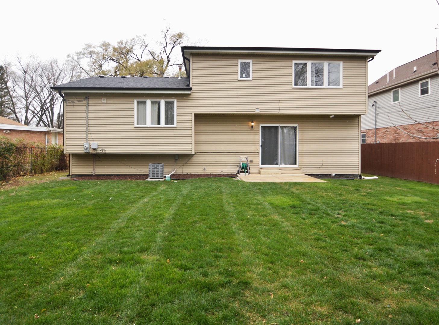 16023 Trumbull Avenue Markham, IL 60428 - Photo 32 of 36 a front view of a house with a garden and yard