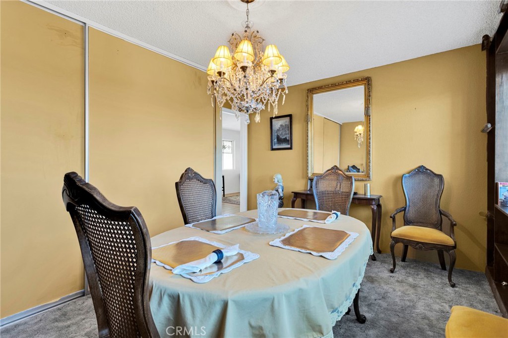 31420 Rabbit Springs Lane Lucerne Valley, CA 92356 - Photo 15 of 72 a view of a dining room with furniture a chandelier and wooden floor