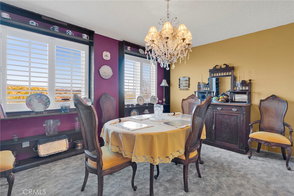 31420 Rabbit Springs Lane Lucerne Valley, CA 92356 - Photo 16 of 72 a view of a dining room with furniture and chandelier