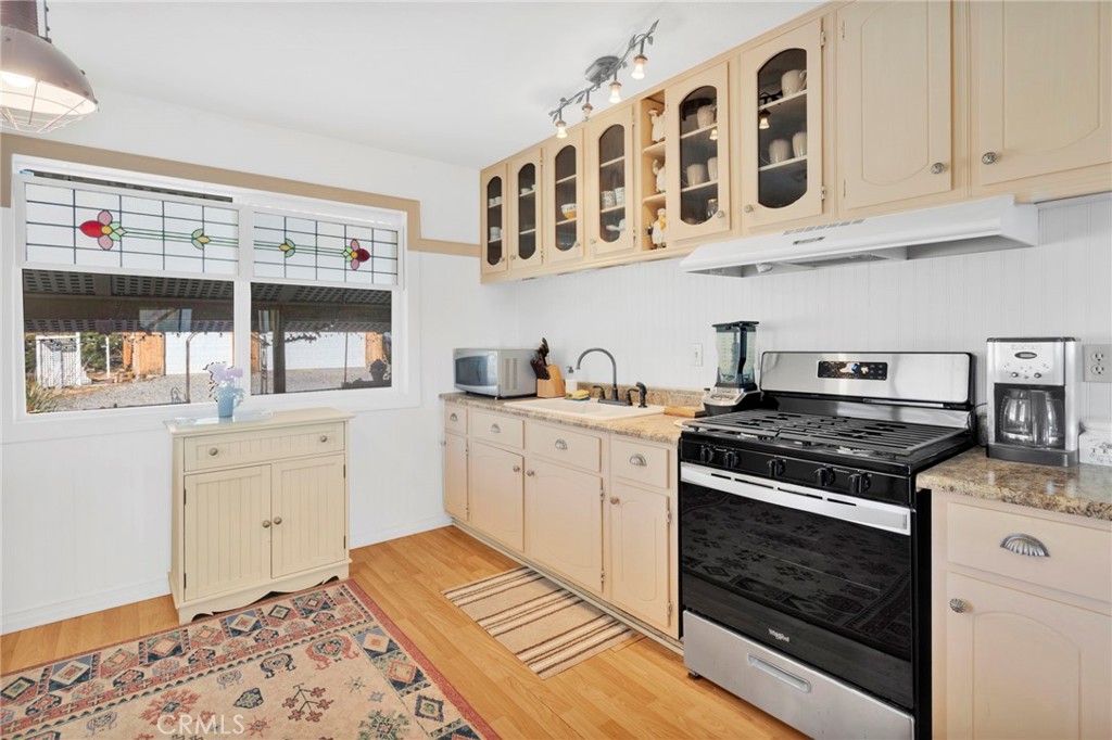31420 Rabbit Springs Lane Lucerne Valley, CA 92356 - Photo 18 of 72 a kitchen with cabinets appliances and a wooden floor