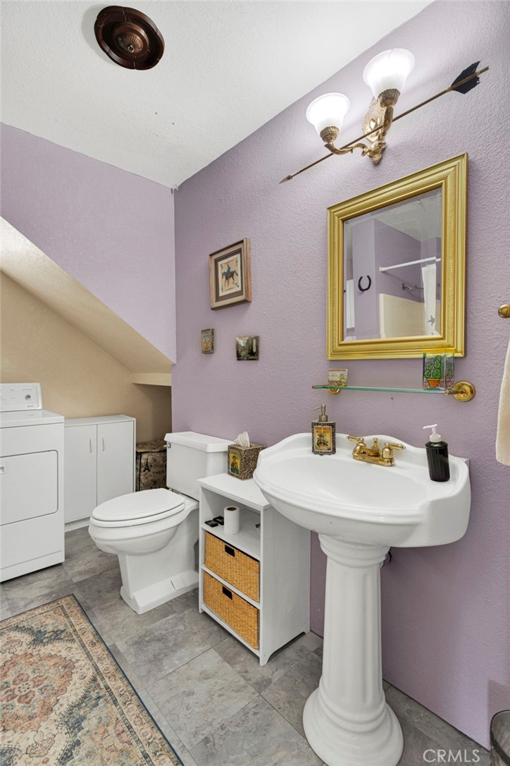 31420 Rabbit Springs Lane Lucerne Valley, CA 92356 - Photo 28 of 72 a bathroom with a toilet sink and mirror