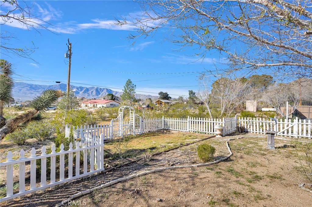 31420 Rabbit Springs Lane Lucerne Valley, CA 92356 - Photo 42 of 72 a view of a balcony with a floor to ceiling window and wooden fence