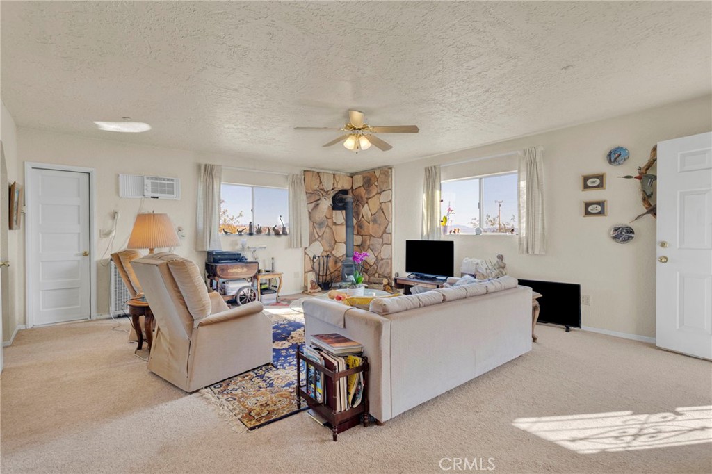 31420 Rabbit Springs Lane Lucerne Valley, CA 92356 - Photo 51 of 72 a living room with furniture and a fireplace