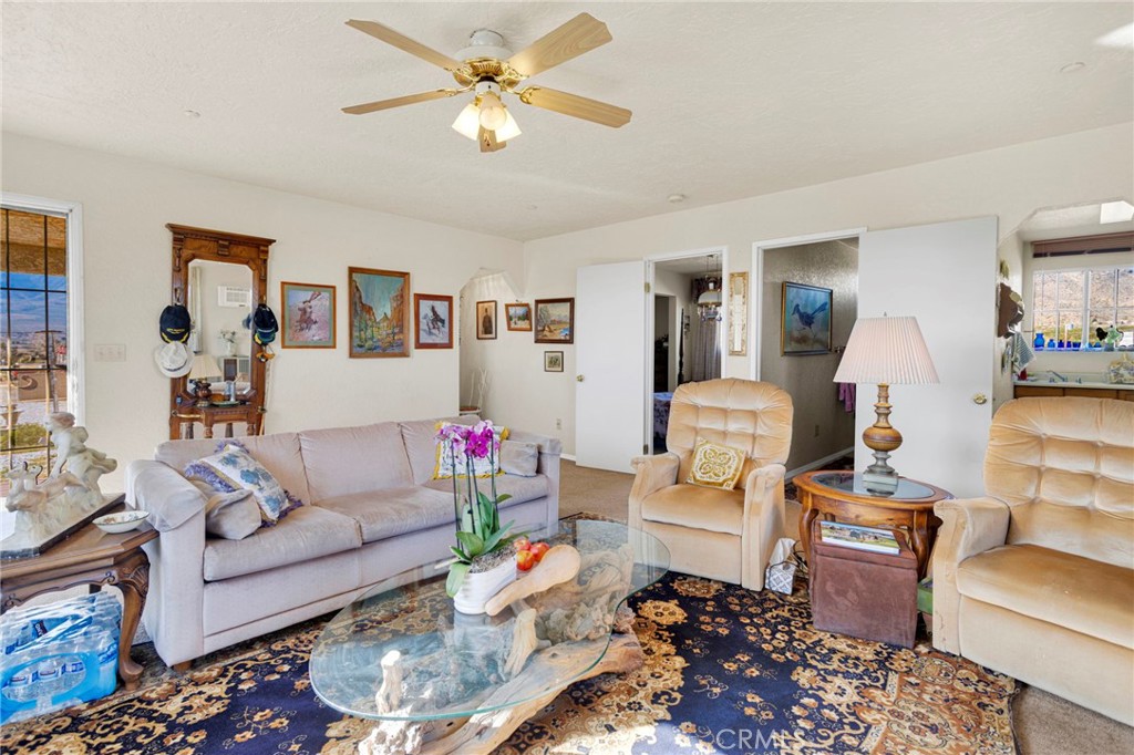 31420 Rabbit Springs Lane Lucerne Valley, CA 92356 - Photo 54 of 72 a living room with furniture and a chandelier