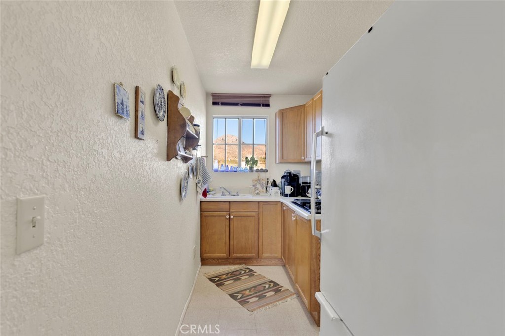 31420 Rabbit Springs Lane Lucerne Valley, CA 92356 - Photo 56 of 72 a kitchen with a refrigerator and a stove top oven