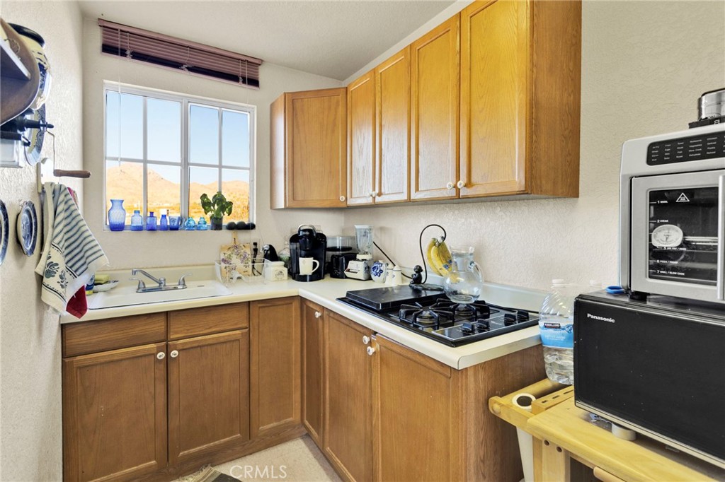 31420 Rabbit Springs Lane Lucerne Valley, CA 92356 - Photo 57 of 72 a kitchen with a sink a stove and cabinets