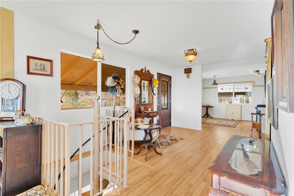 31420 Rabbit Springs Lane Lucerne Valley, CA 92356 - Photo 7 of 72 a view of a livingroom with furniture wooden floor windows and a chandelier