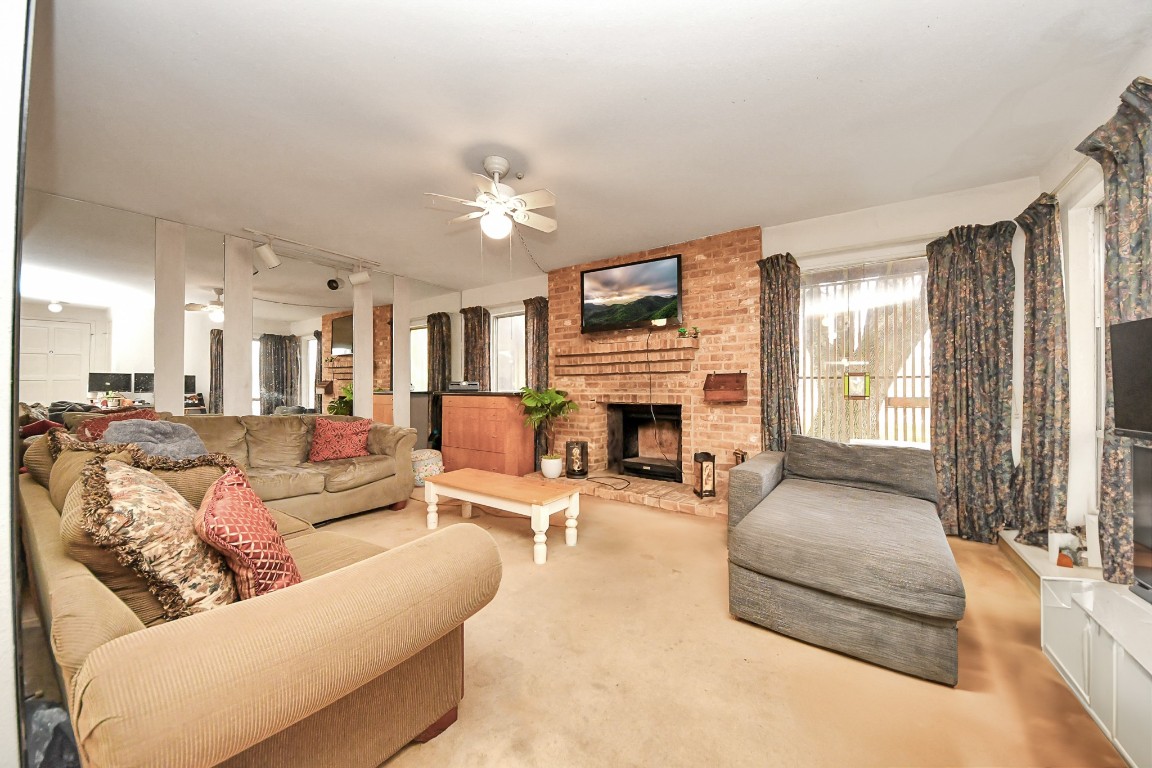7728 Challie Lane Houston, TX 77088 - Photo 12 of 28 a living room with furniture and a fireplace