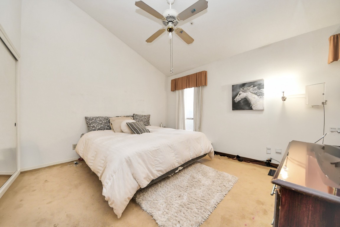 7728 Challie Lane Houston, TX 77088 - Photo 16 of 28 a bedroom with a bed and a ceiling fan