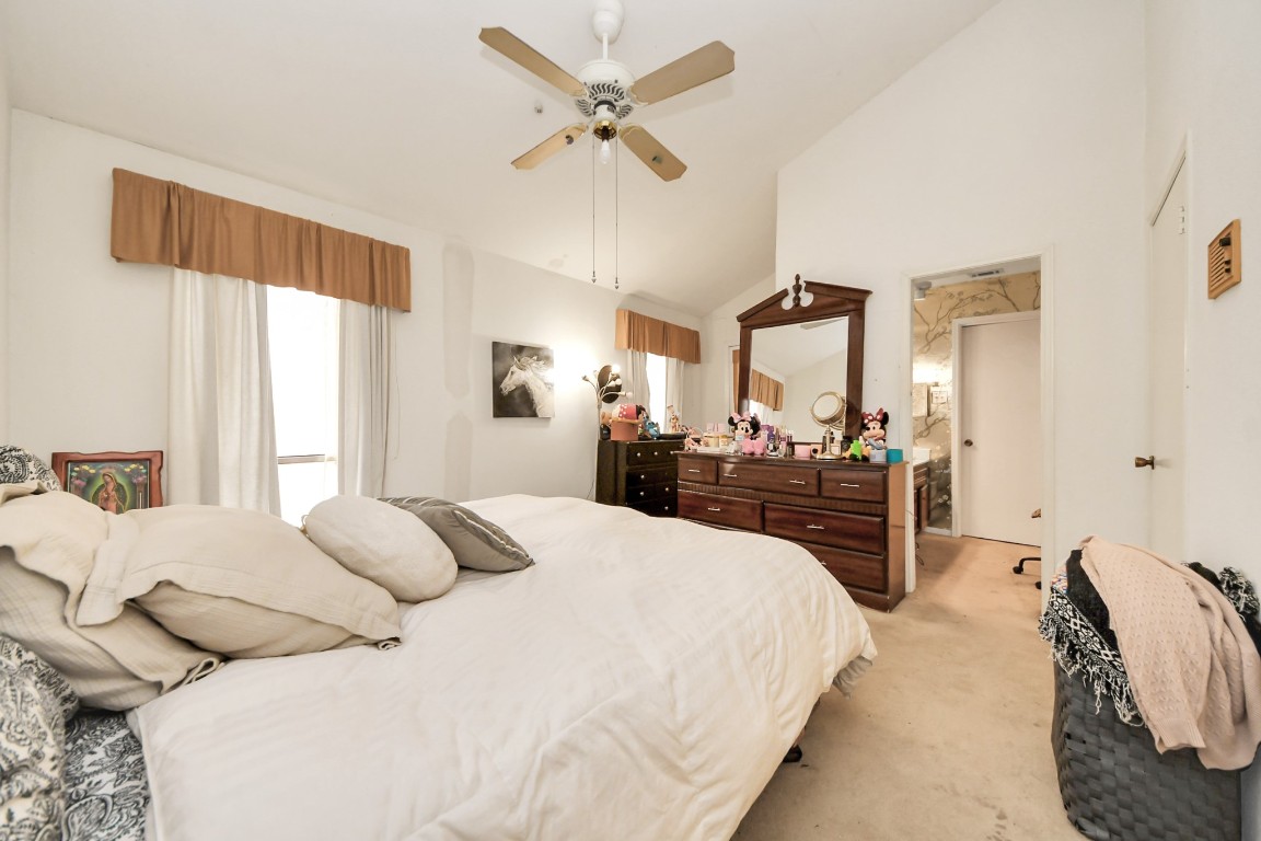 7728 Challie Lane Houston, TX 77088 - Photo 17 of 28 a large bedroom with a bed and a large mirror