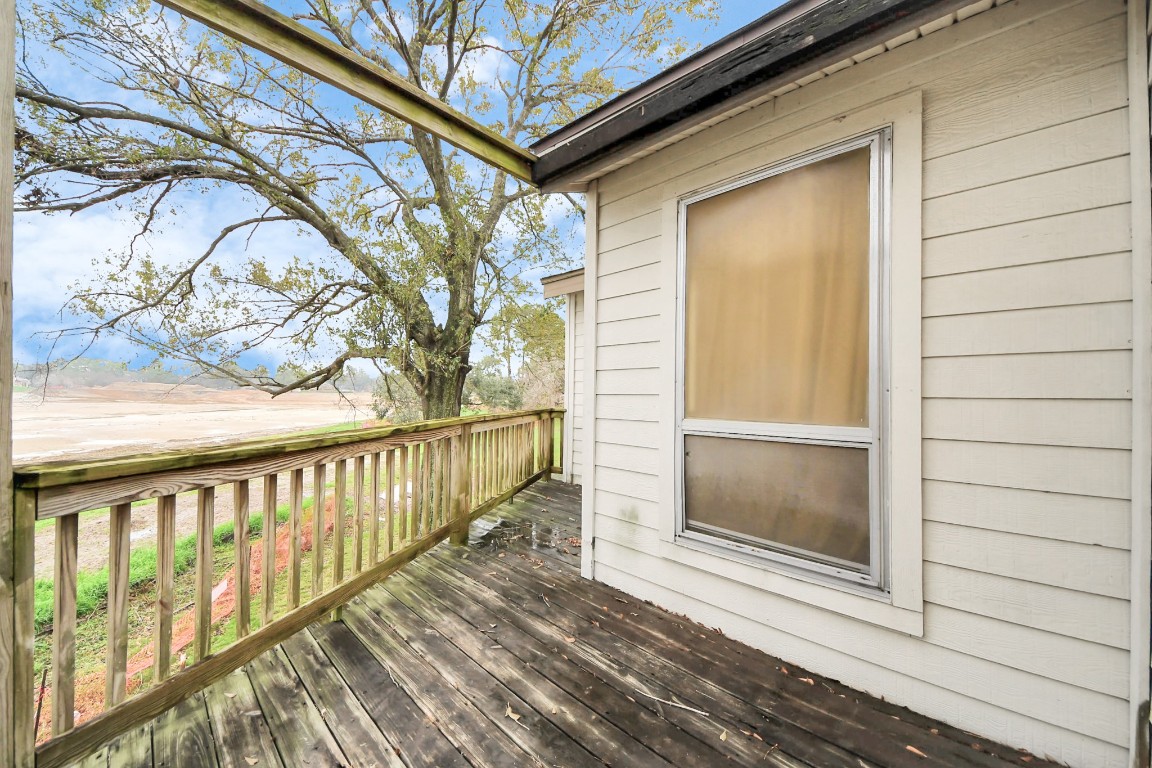 7728 Challie Lane Houston, TX 77088 - Photo 19 of 28 a view of a porch with wooden floor and fence