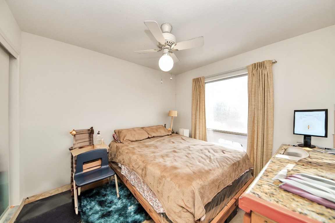 7728 Challie Lane Houston, TX 77088 - Photo 20 of 28 a bedroom with a bed and a chandelier