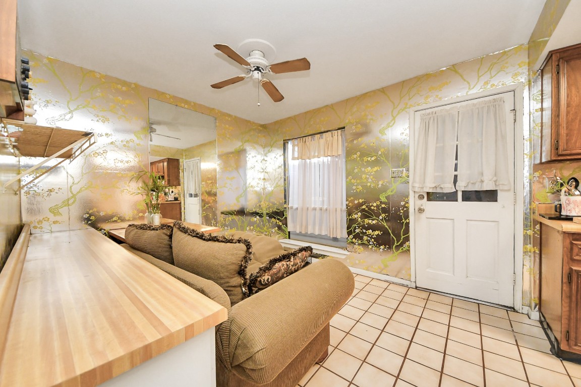 7728 Challie Lane Houston, TX 77088 - Photo 7 of 28 a living room with furniture and a chandelier