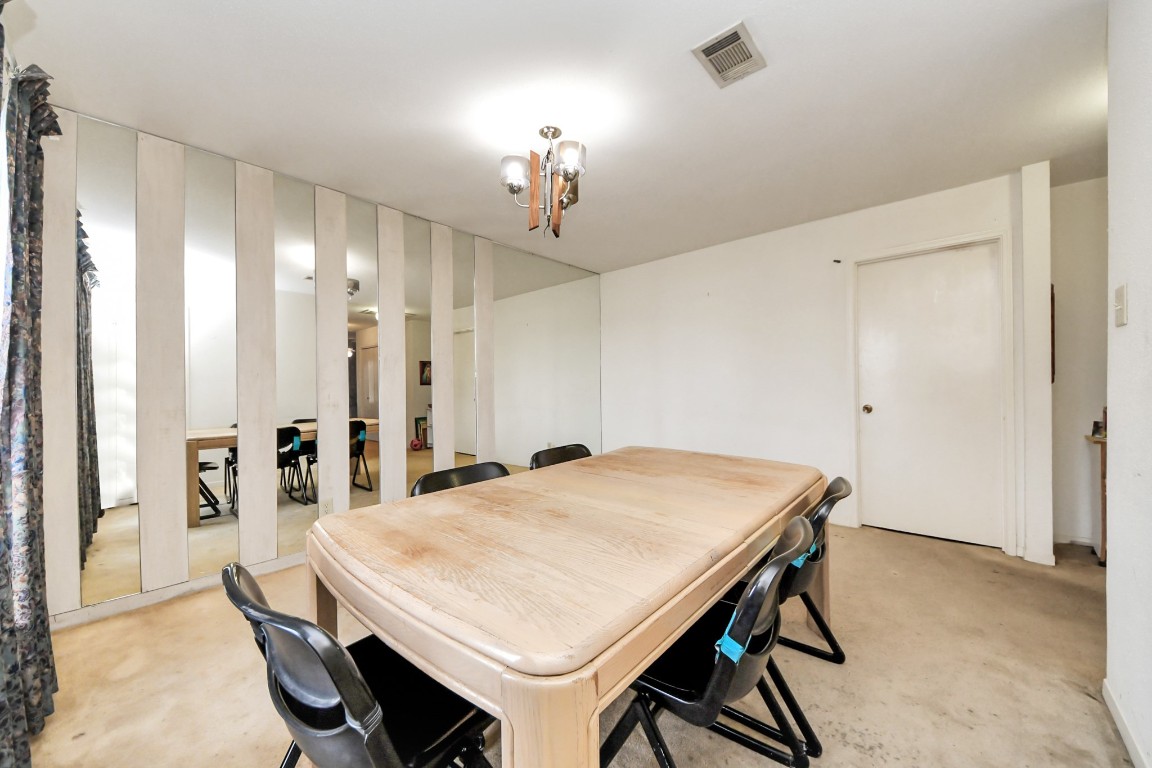 7728 Challie Lane Houston, TX 77088 - Photo 10 of 28 a view of a dining room with furniture and chandelier