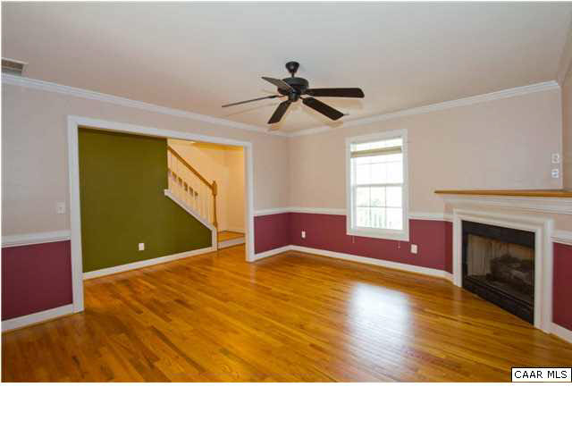 93 Riverside Drive Palmyra, VA 22963 - Photo 5 of 21 a view of empty room with a fireplace and wooden floor