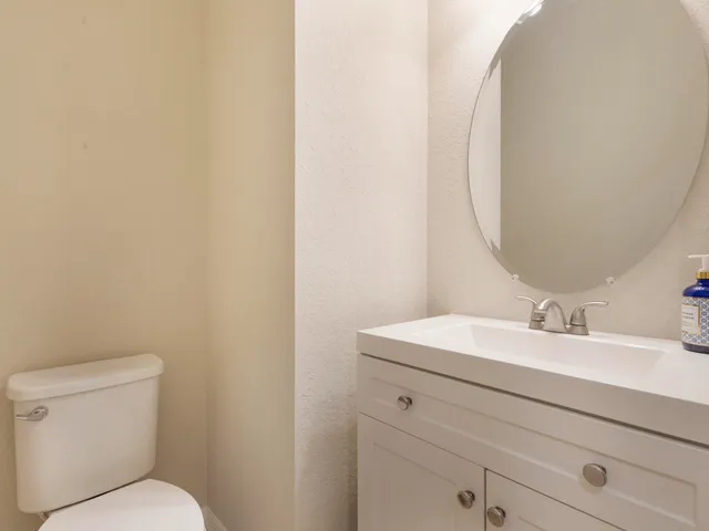 a view of a hallway with entryway closet and wooden floor