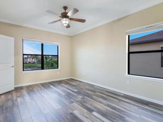 a view of room with hardwood floor and ceiling fan