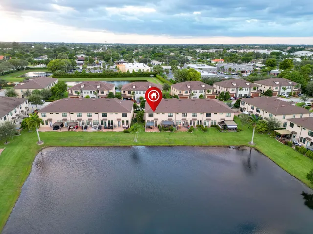 an aerial view of house with outdoor space and seating