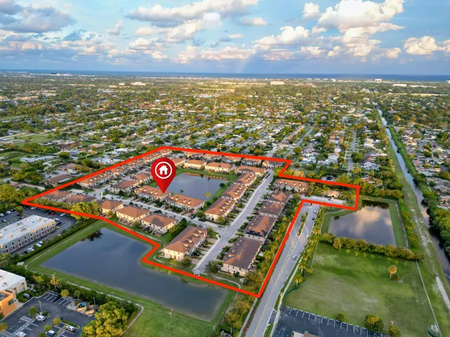 an aerial view of residential houses with city view