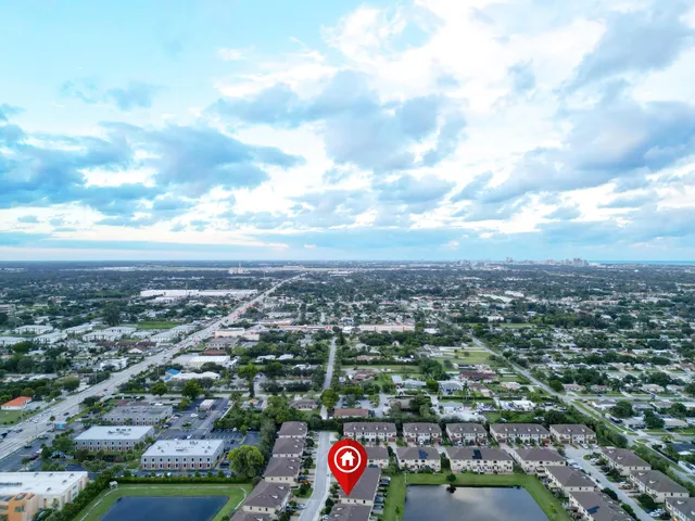 an aerial view of city lake and trees