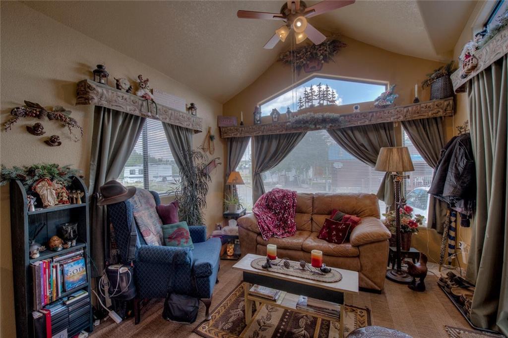92 Sunshine Loop Fairplay, CO 80440 - Photo 11 of 35 a living room with lots of furniture and a chandelier