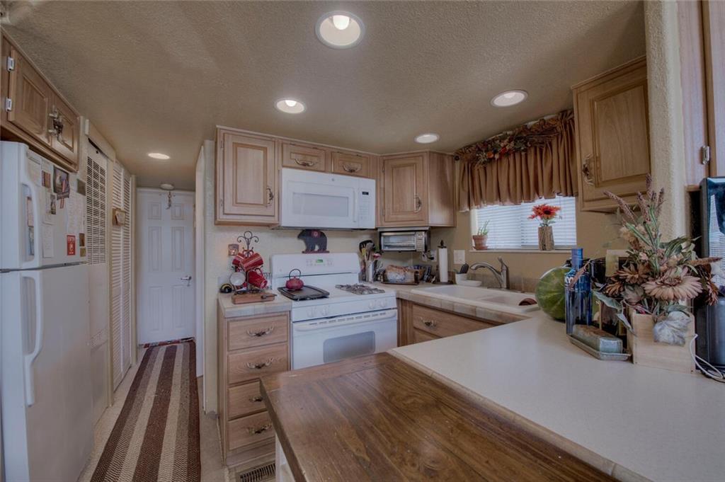92 Sunshine Loop Fairplay, CO 80440 - Photo 17 of 35 a kitchen that has a lot of cabinets a sink and appliances