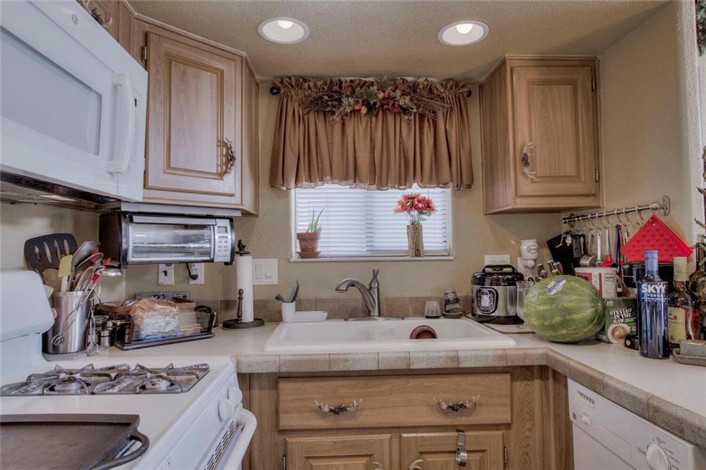 92 Sunshine Loop Fairplay, CO 80440 - Photo 19 of 35 a kitchen with kitchen island granite countertop a sink stove and cabinets