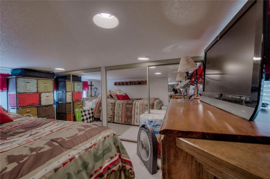 92 Sunshine Loop Fairplay, CO 80440 - Photo 26 of 35 a bed room with a bed and a mirror