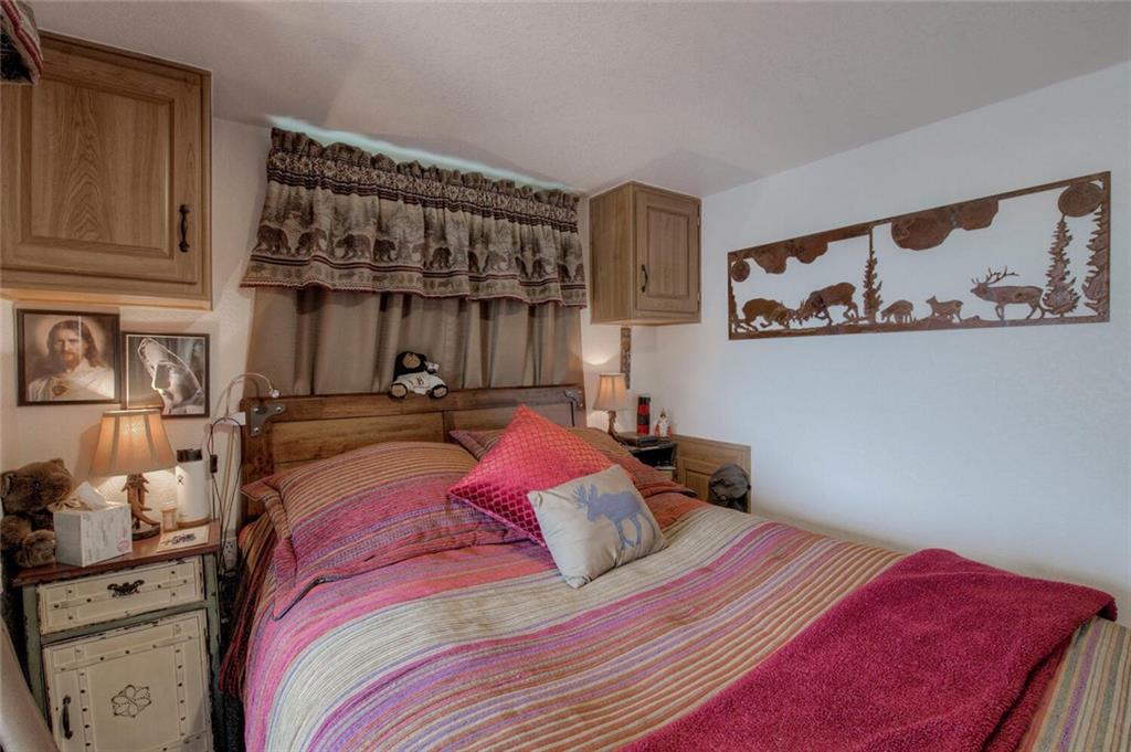 92 Sunshine Loop Fairplay, CO 80440 - Photo 29 of 35 a bed sitting in a bedroom next to a window