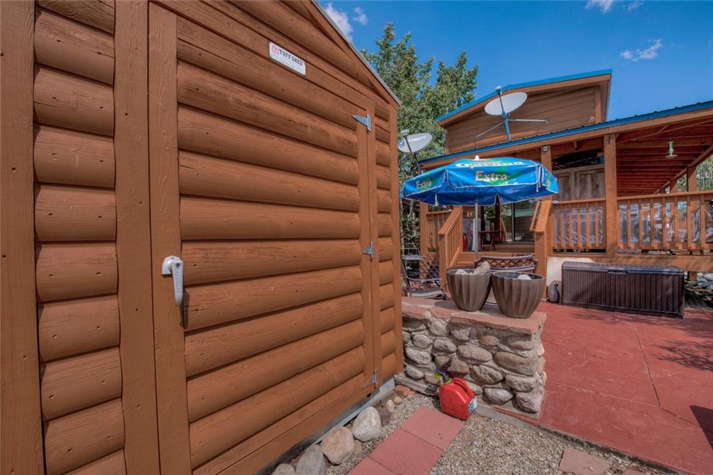 92 Sunshine Loop Fairplay, CO 80440 - Photo 9 of 35 a view of a backyard with table and chairs under an umbrella