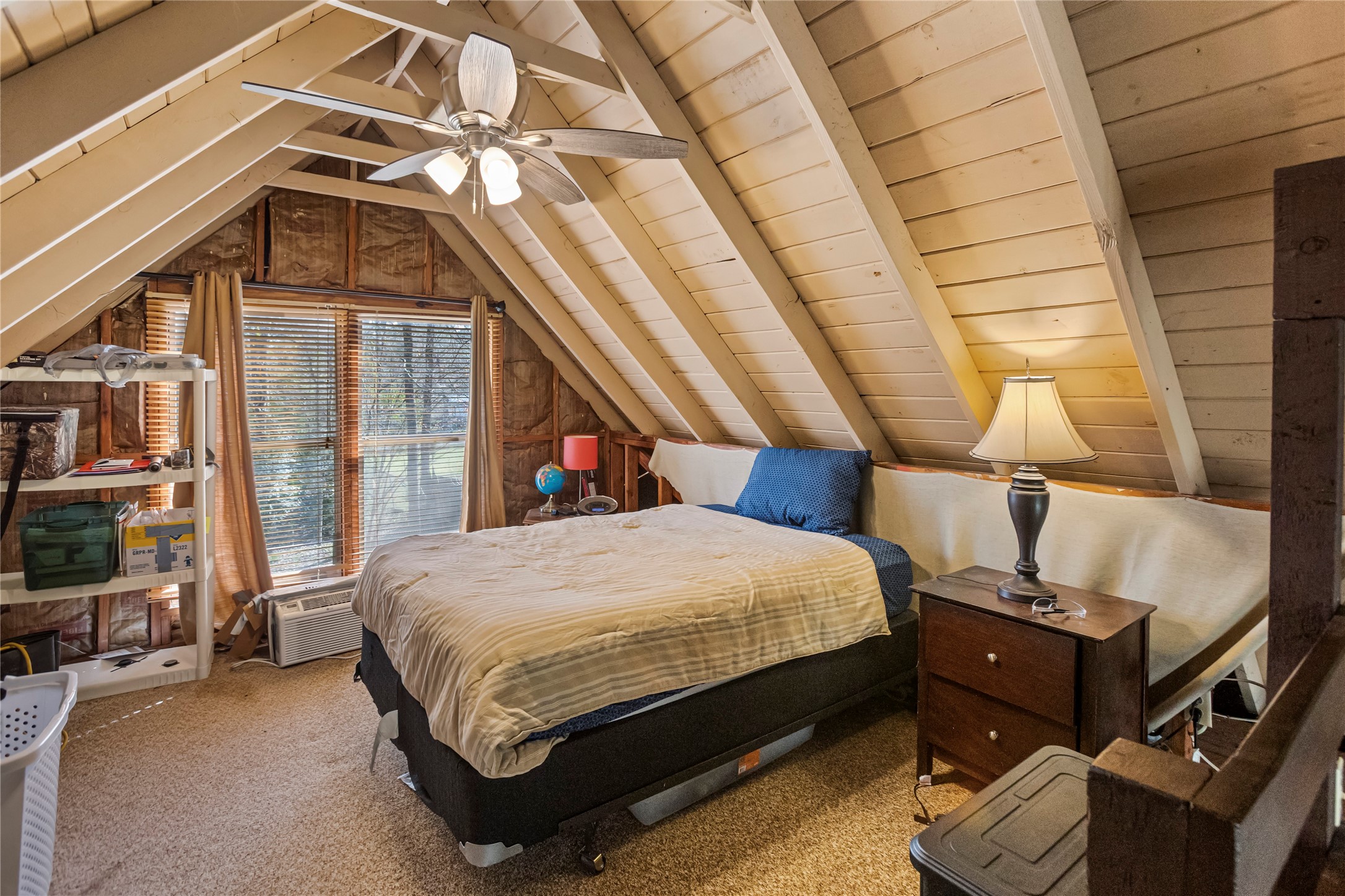 20 Shannon Street Huntsville, TX 77320 - Photo 11 of 29 a bed sitting in a bedroom next to a window