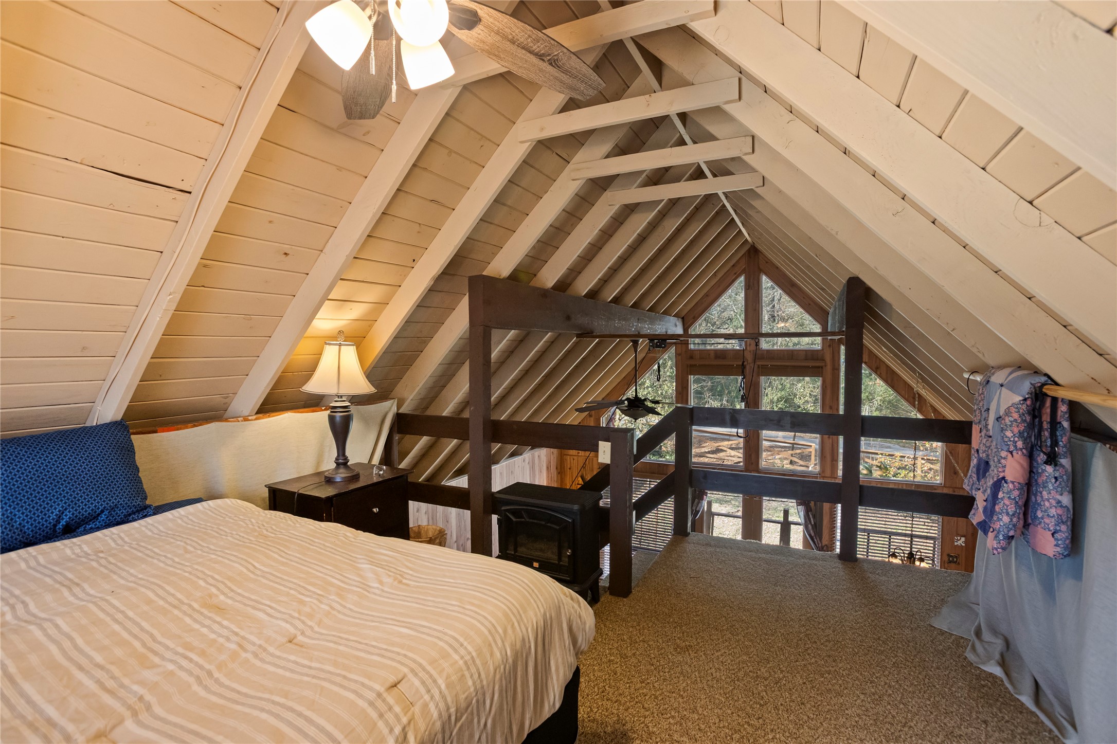 20 Shannon Street Huntsville, TX 77320 - Photo 12 of 29 a bed room with a bed and a book shelf