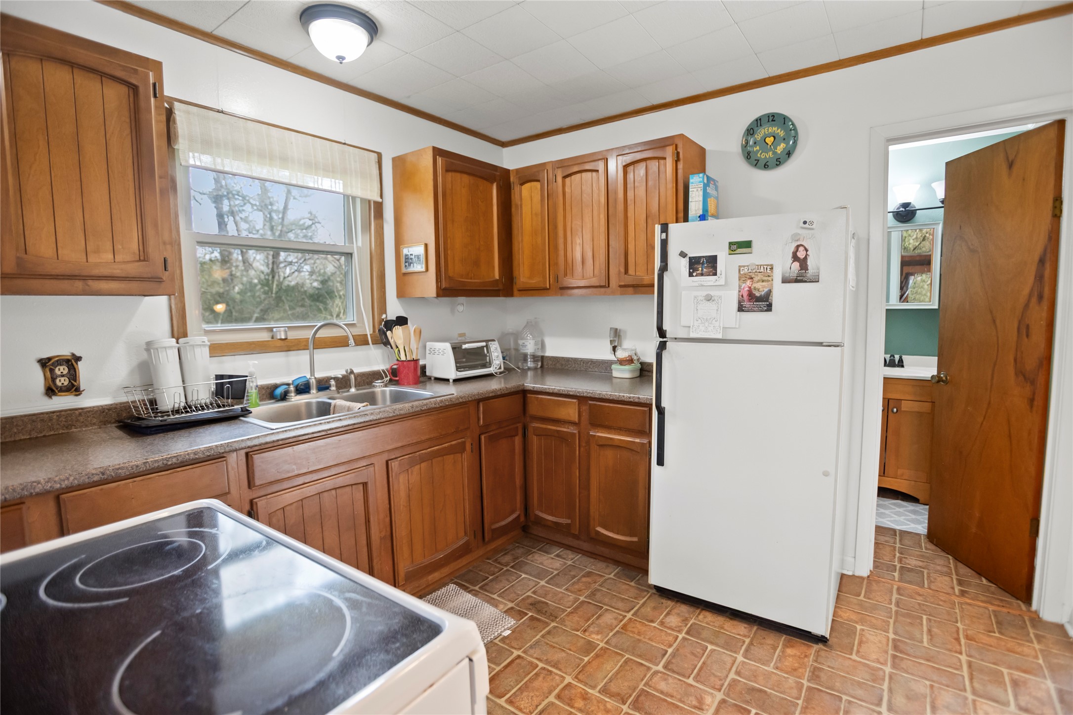 20 Shannon Street Huntsville, TX 77320 - Photo 16 of 29 a kitchen with a refrigerator a sink dishwasher and cabinets with wooden floor