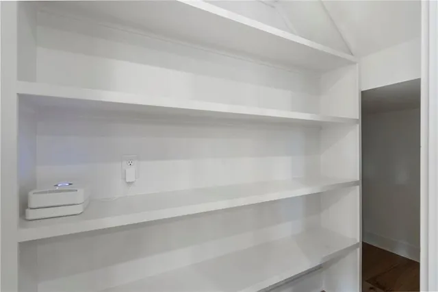 a kitchen with stainless steel appliances kitchen island a refrigerator and a wooden floors