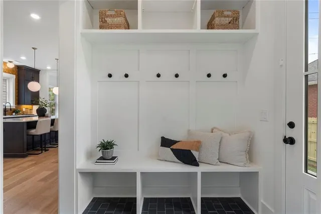 a bedroom with a bed a window and a chandelier