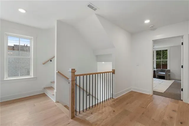 a bedroom with a bed a couch and a painting on the wall