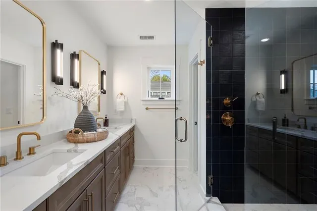 a bathroom with a toilet a sink a tub a mirror and vanity