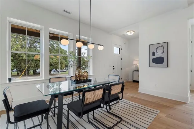 a large kitchen with a table and chairs