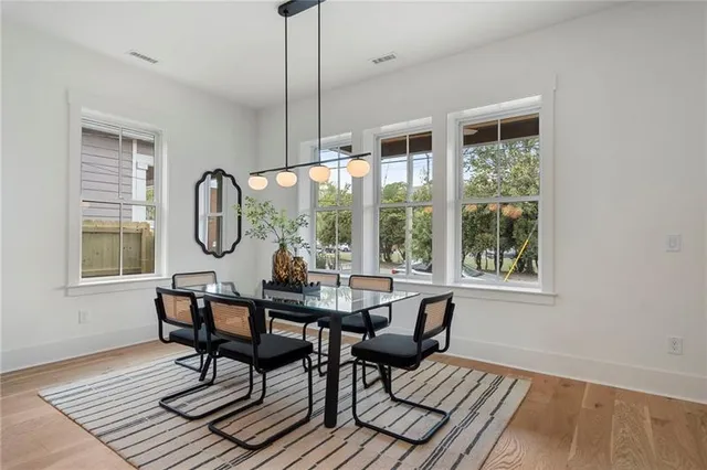 a large kitchen with kitchen island a large counter top a sink a stove and a refrigerator