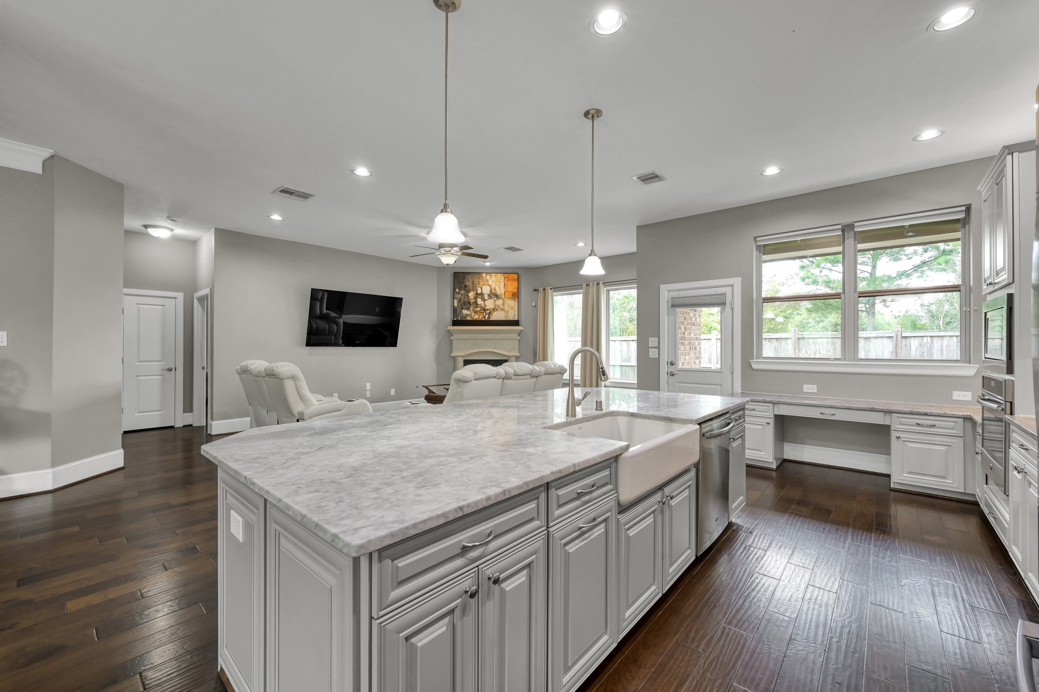 31714 Pierwood Court Spring, TX 77386 - Photo 21 of 49 a large kitchen with kitchen island a stove a sink a center island and wooden floor