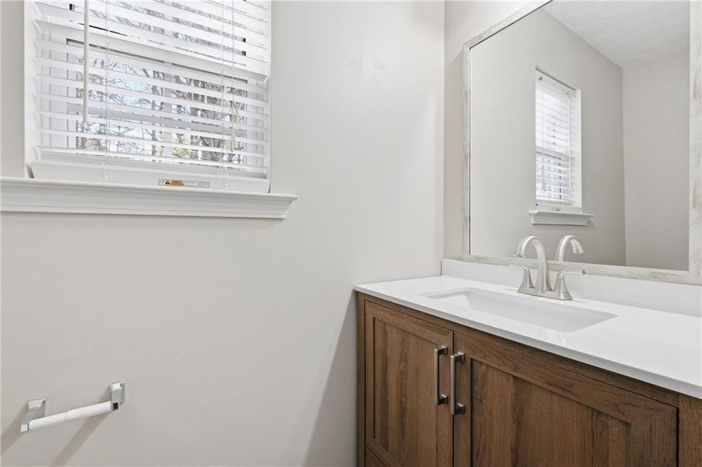 3570 Bogan Mill Road Northeast Buford, GA 30519 - Photo 13 of 31 a bathroom with a sink a vanity and a window