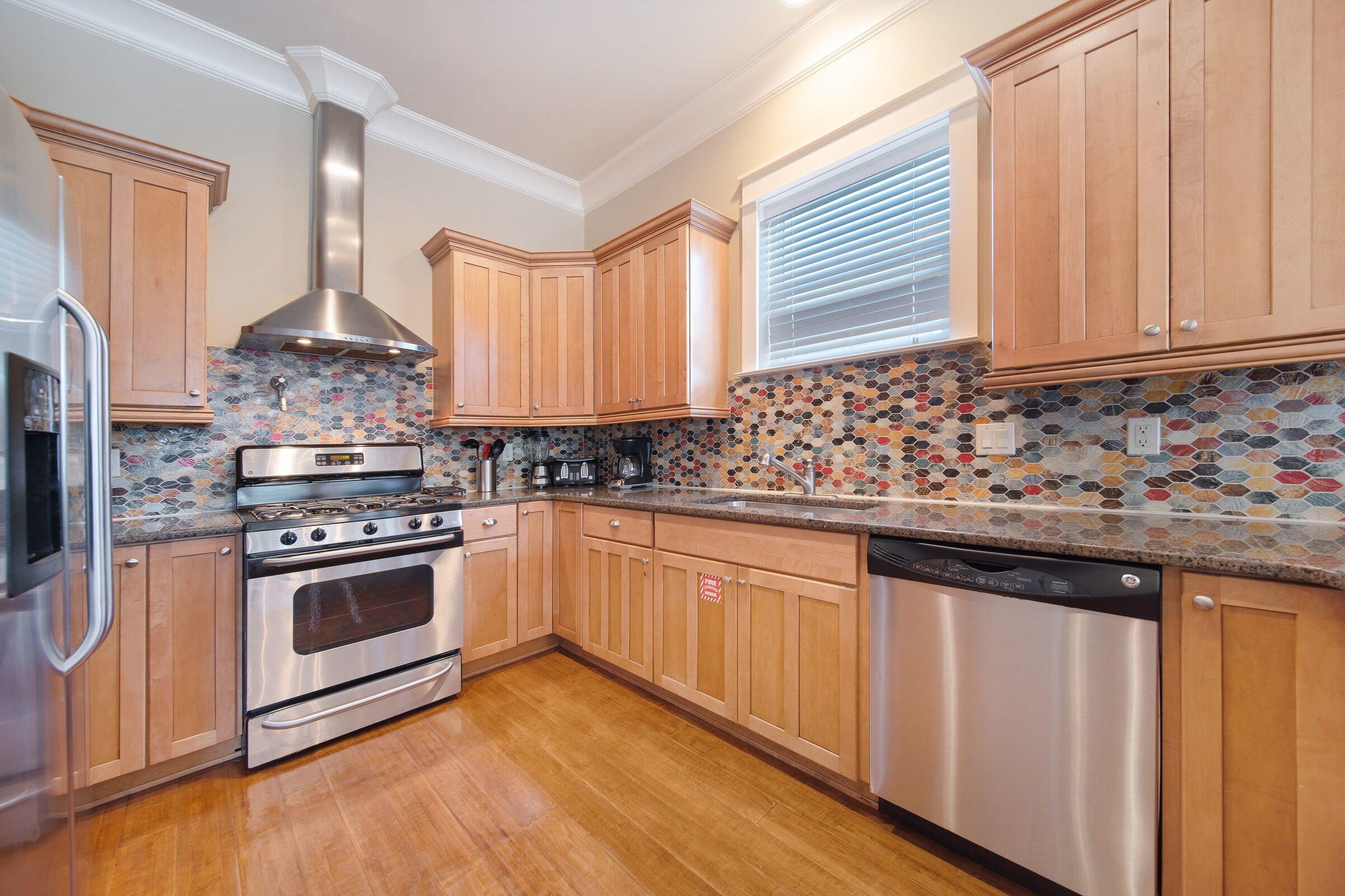 4836 Ocean Boulevard Destin, FL 32541 - Photo 14 of 71 a kitchen with stainless steel appliances granite countertop a stove a sink and a microwave