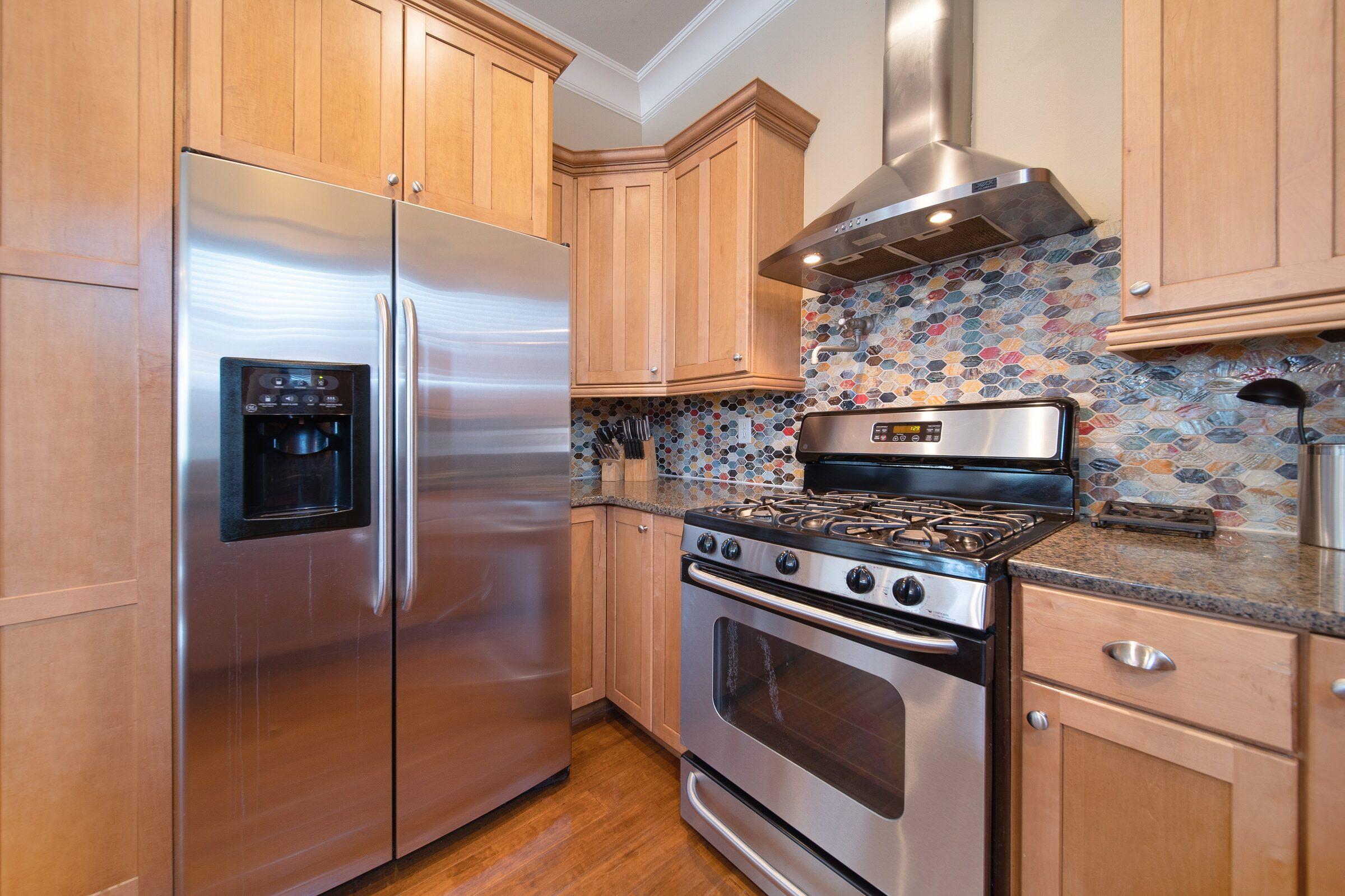 4836 Ocean Boulevard Destin, FL 32541 - Photo 15 of 71 a kitchen with stainless steel appliances granite countertop a stove and a refrigerator