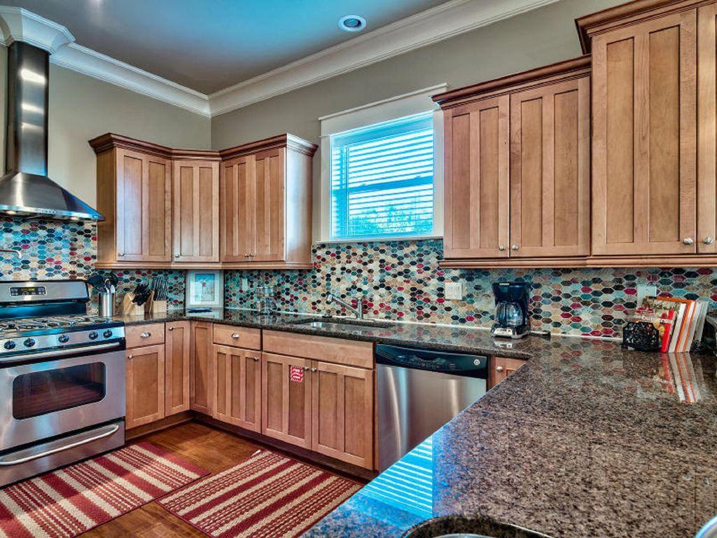 4836 Ocean Boulevard Destin, FL 32541 - Photo 21 of 71 a kitchen with stainless steel appliances granite countertop a stove a sink and a microwave