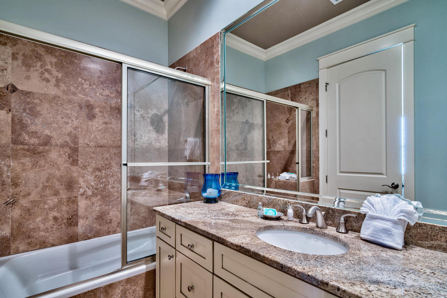 4836 Ocean Boulevard Destin, FL 32541 - Photo 25 of 71 a bathroom with a granite countertop sink and a mirror