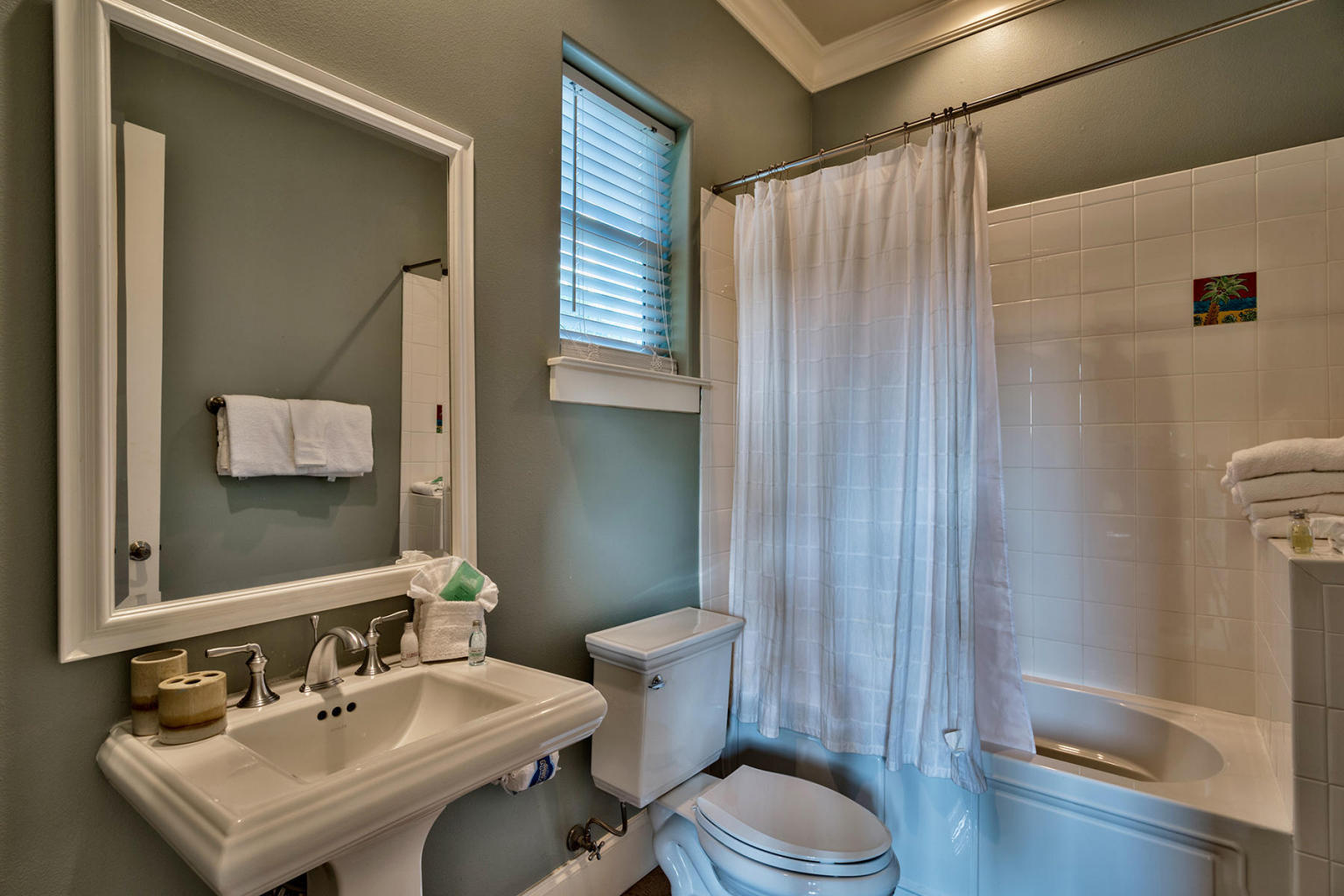 4836 Ocean Boulevard Destin, FL 32541 - Photo 27 of 71 a bathroom with a sink a toilet a mirror and shower
