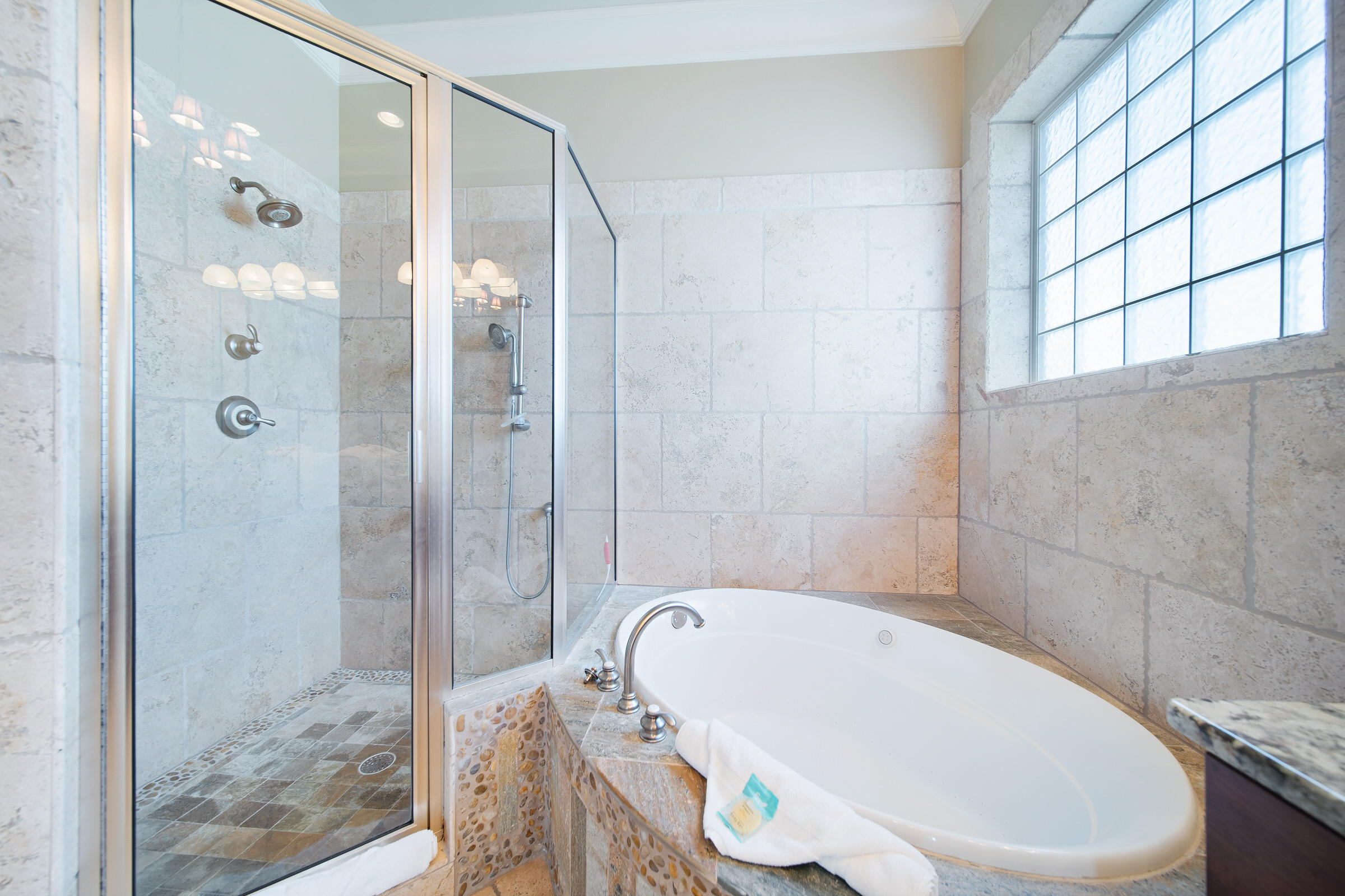 4836 Ocean Boulevard Destin, FL 32541 - Photo 32 of 71 a bathroom with a white bath tub a shower and a sink