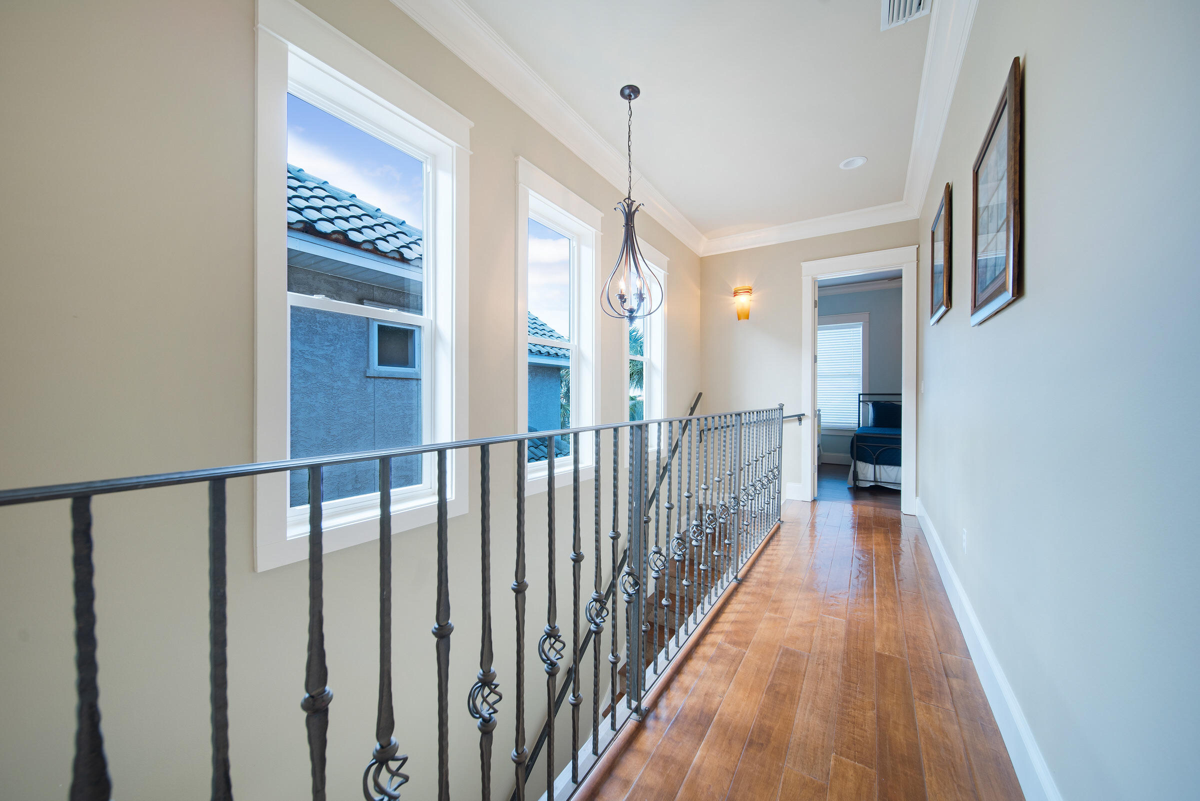 4836 Ocean Boulevard Destin, FL 32541 - Photo 37 of 71 a view of a hallway with wooden floor and staircase