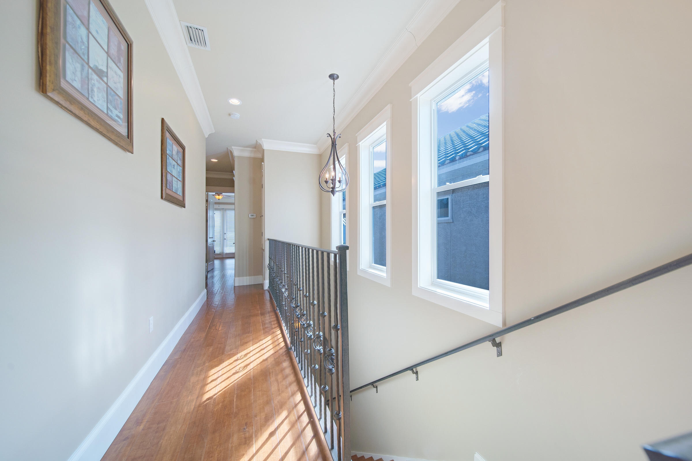 4836 Ocean Boulevard Destin, FL 32541 - Photo 43 of 71 a view of a hallway with wooden floor and staircase