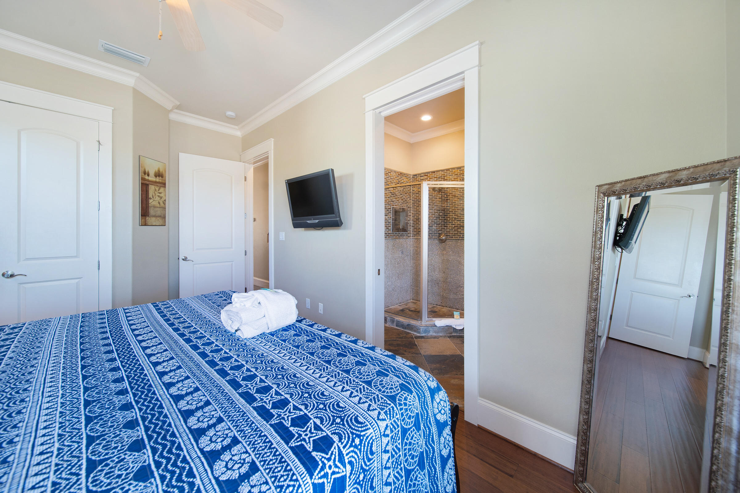 4836 Ocean Boulevard Destin, FL 32541 - Photo 49 of 71 a bedroom with a bed and a flat screen tv
